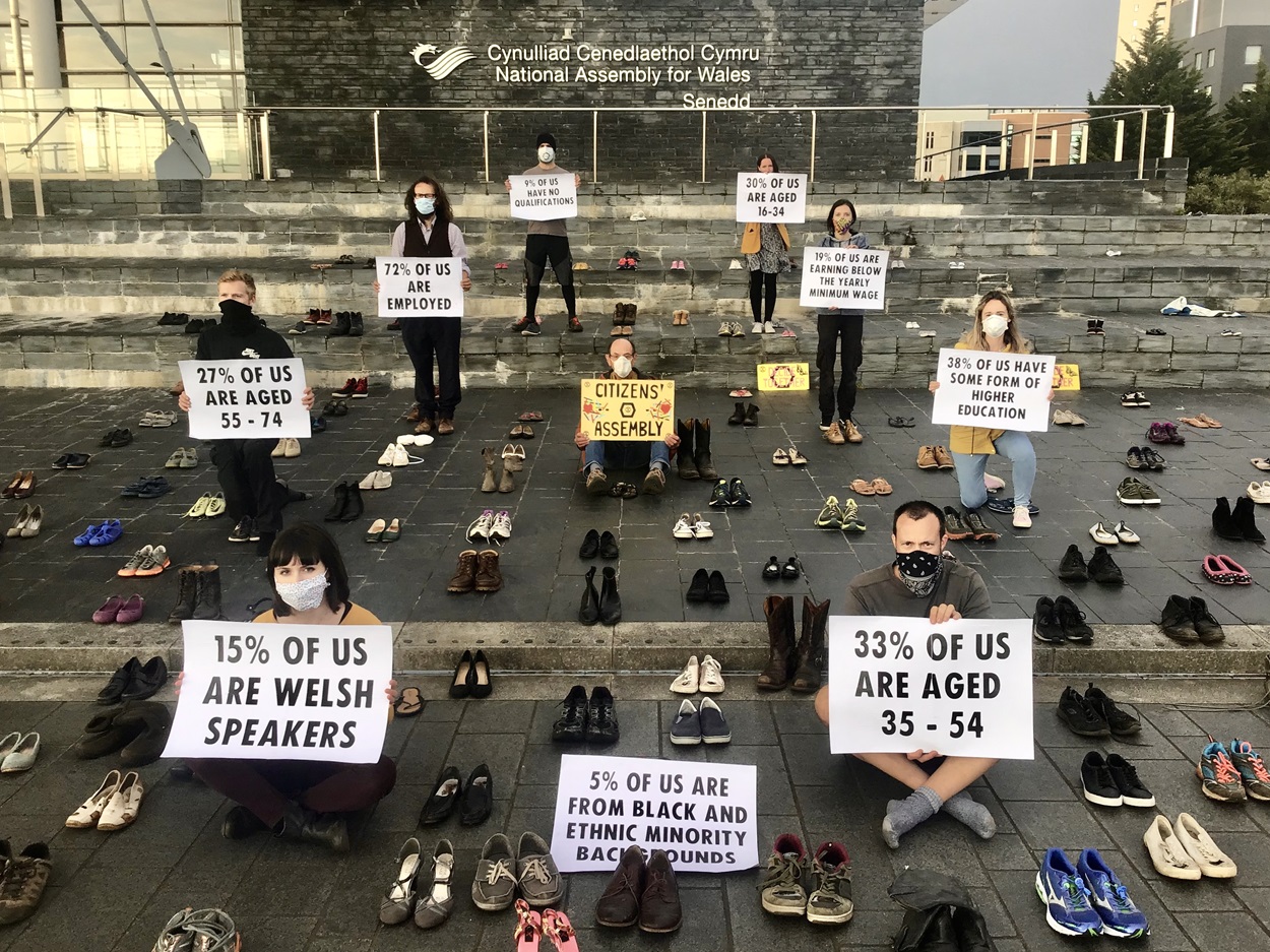 CA action with rebels holding placards and pairs of shoes representing other people in between