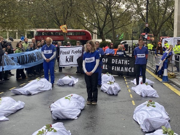 Health professional in sombre die-in action on road outside conference