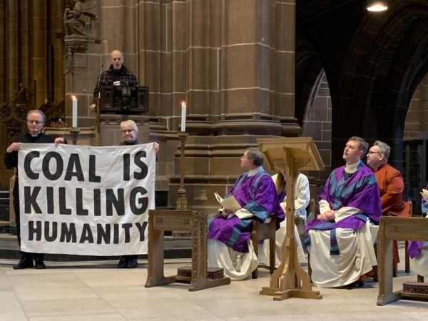 Coal is killing humanity large banner protest at church service