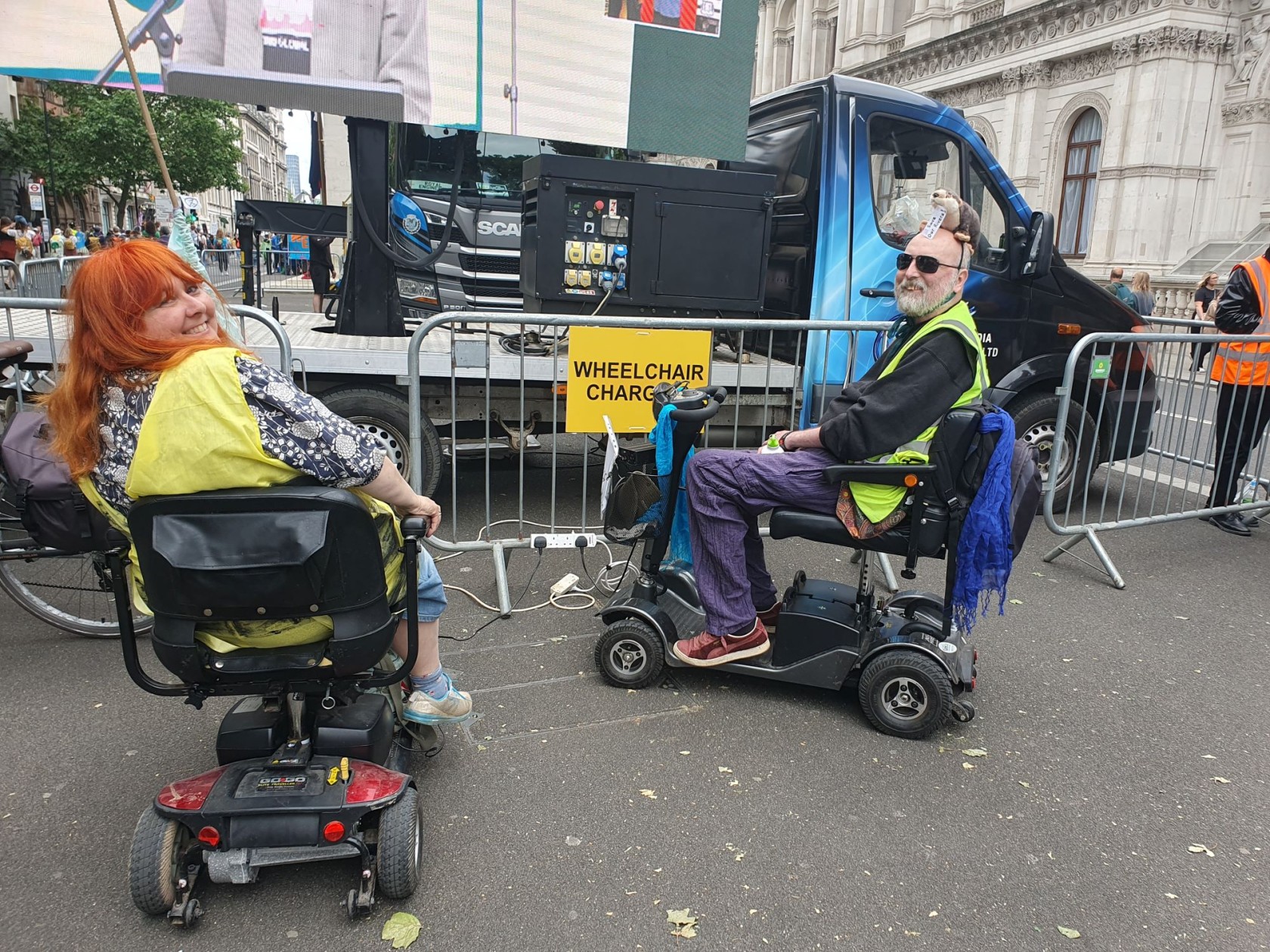 two people in wheelchairs in front of a stage