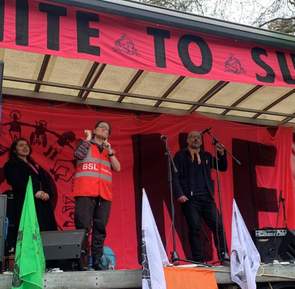 people on a stage with a BSL interpreter