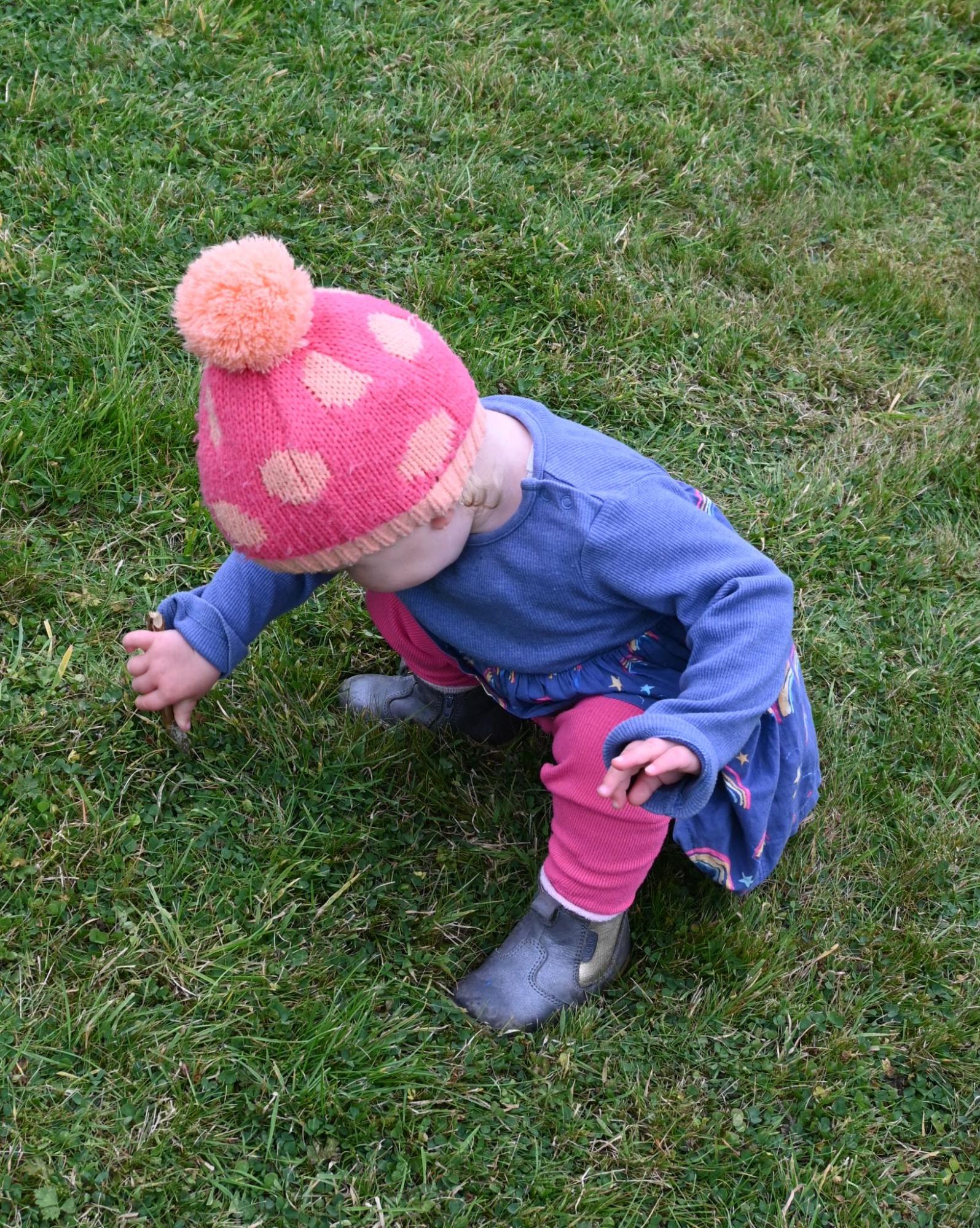 small child exploring grass